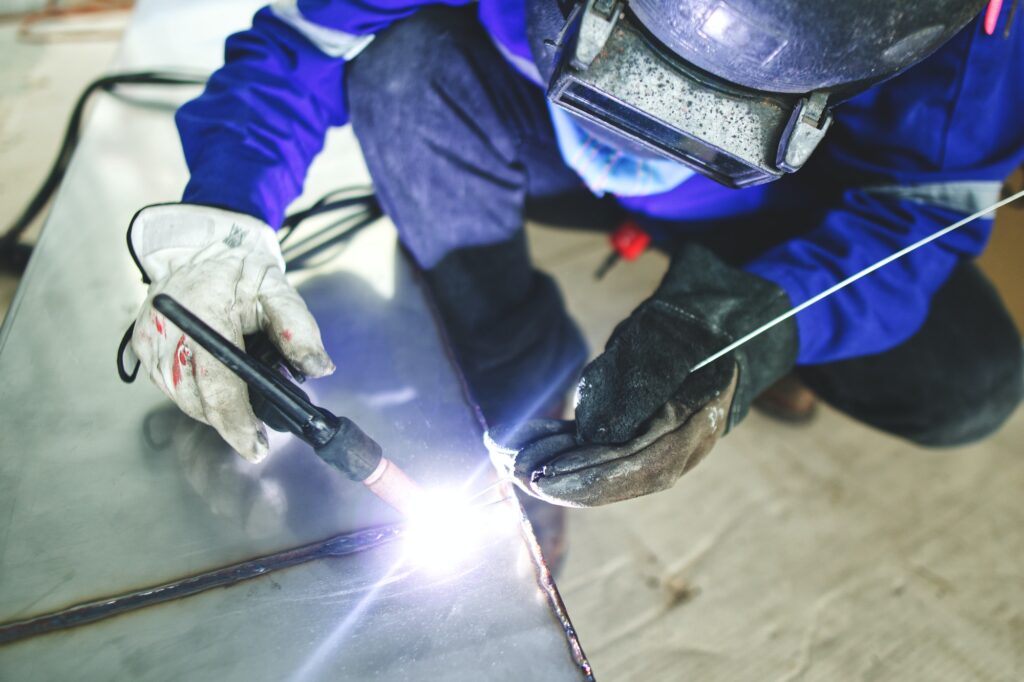 The technician is welding stainless steel pipes by argon welding.